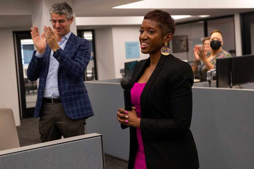 Publisher Grant Moise (left) claps after The Dallas Morning News' new executive editor,...