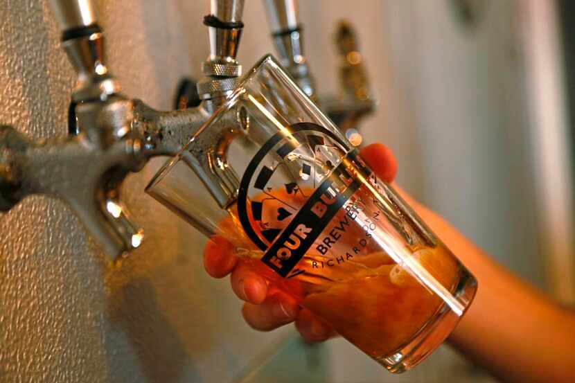 
A beer is poured at Four Bullets Brewery in Richardson on July 25.
