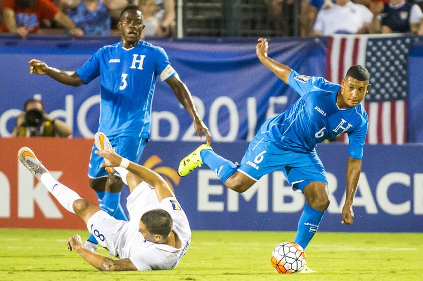 Honduras midfielder Bryan Acosta (6) gets past USA forward Clint Dempsey (8) during the...