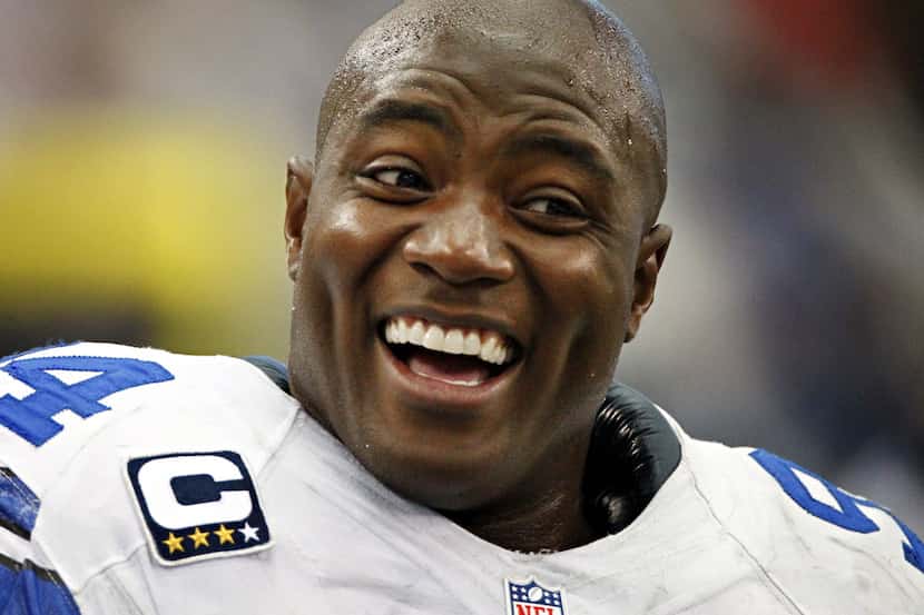 Dallas Cowboys defensive end DeMarcus Ware laughs on the sidelines during the second half of...
