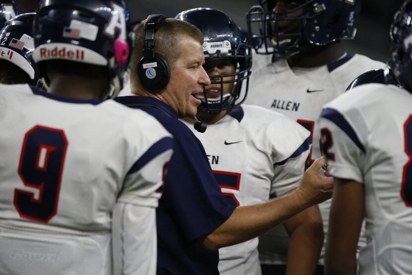 Allen High School head coach Tom Westerberg talks to his players during a time out in the...