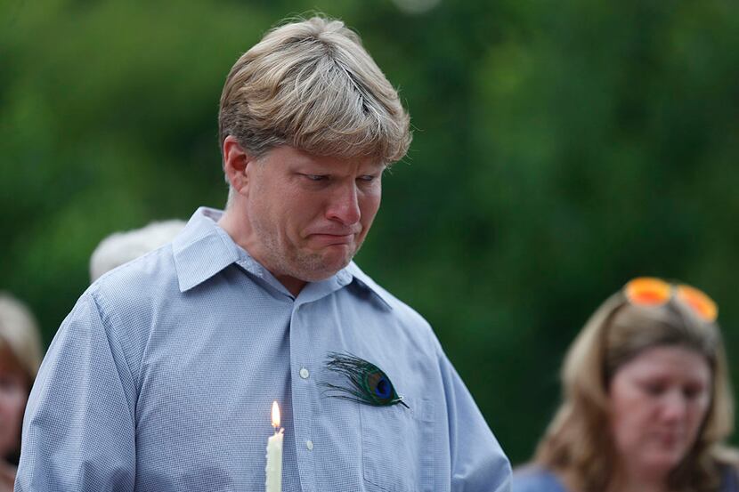  Jason Hitt tears up while reading a letter during a candlelight vigil for his girlfriend...