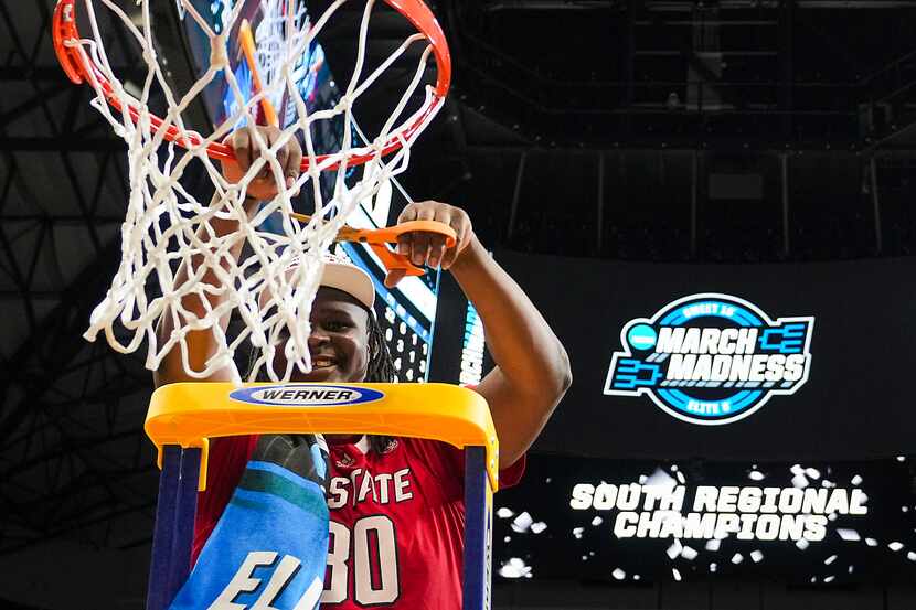 North Carolina State forward DJ Burns Jr. cuts the net after a victory over Duke in the NCAA...