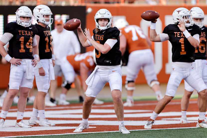 Texas Longhorns quarterbacks Quinn Ewers (3) and Hudson Card (1) throw passes during warmups...