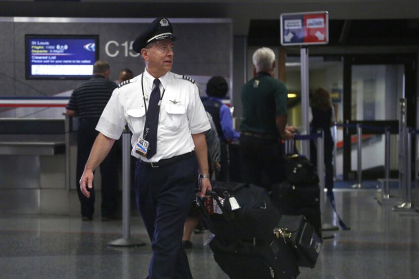 An American Airlines pilot gets off a flight at Terminal C at D/FW Airport. A spokesman for...