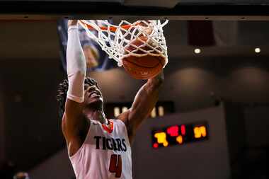 Lancaster's Dillon Battie dunks the ball during a boys high school basketball game against...