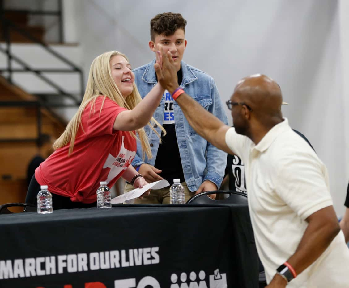 Jaclyn Corin (left) high-fives Michael Sorrell, president of Paul Quinn College, during a...