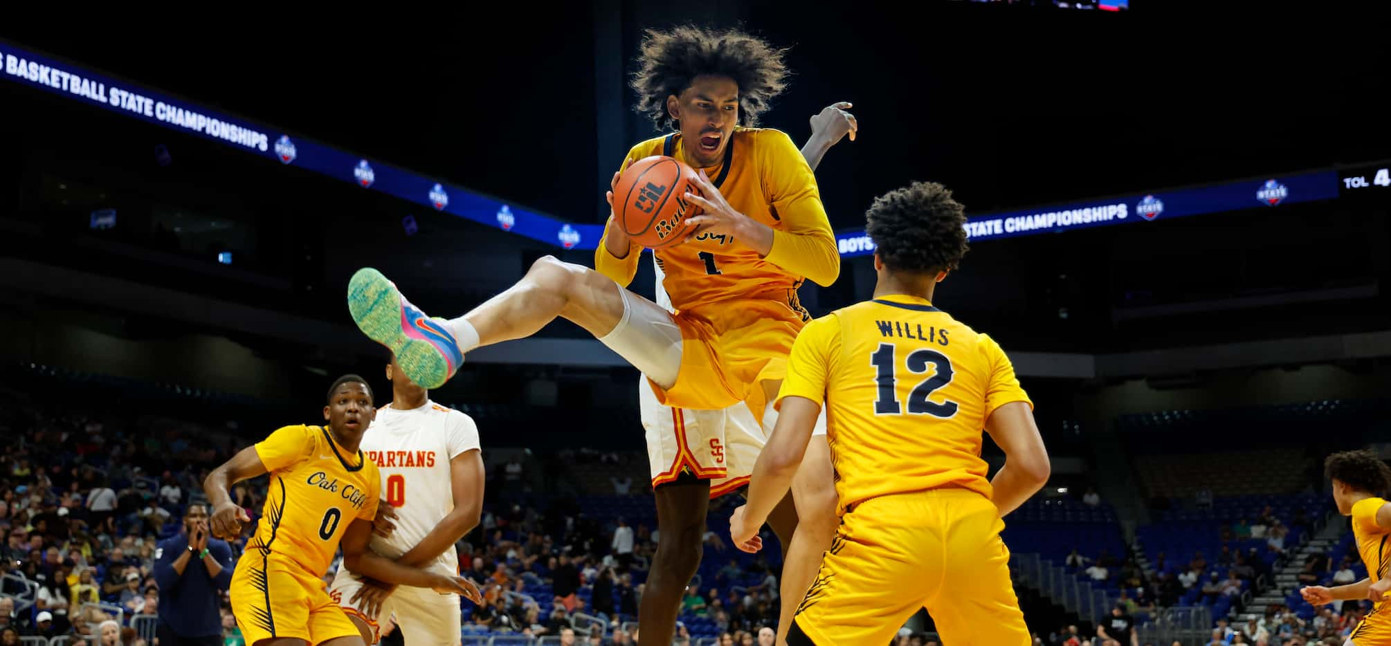 Faith Family's Doryan Onwuchekwa (1) grabs a rebound against Stafford in the first half of a...