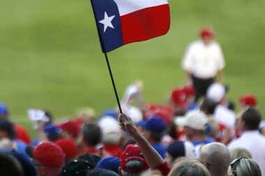 A Texas Rangers fan waves the state flag before their American League Division Series...