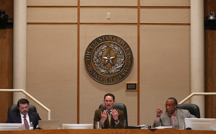 Dallas County Judge Clay Jenkins (middle) speaks alongside Dallas County Commissioners J.J....