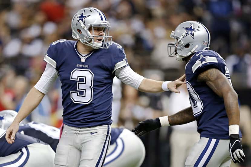 Dallas Cowboys quarterback Brandon Weeden (3) and running back Darren McFadden confer at the...