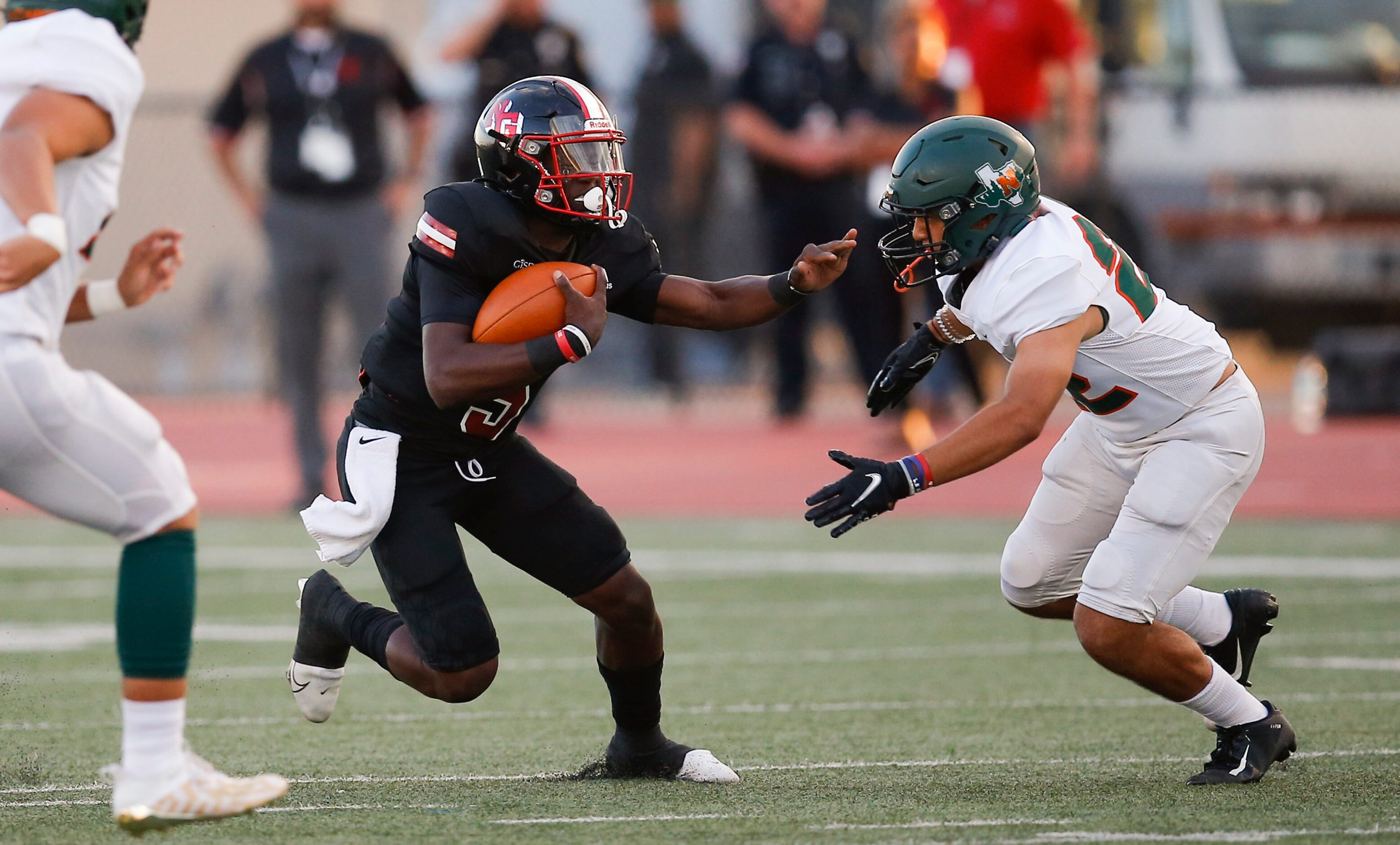 Garland Naaman Forest sophomore defensive back Jason Flores, rights tackles North Garland...