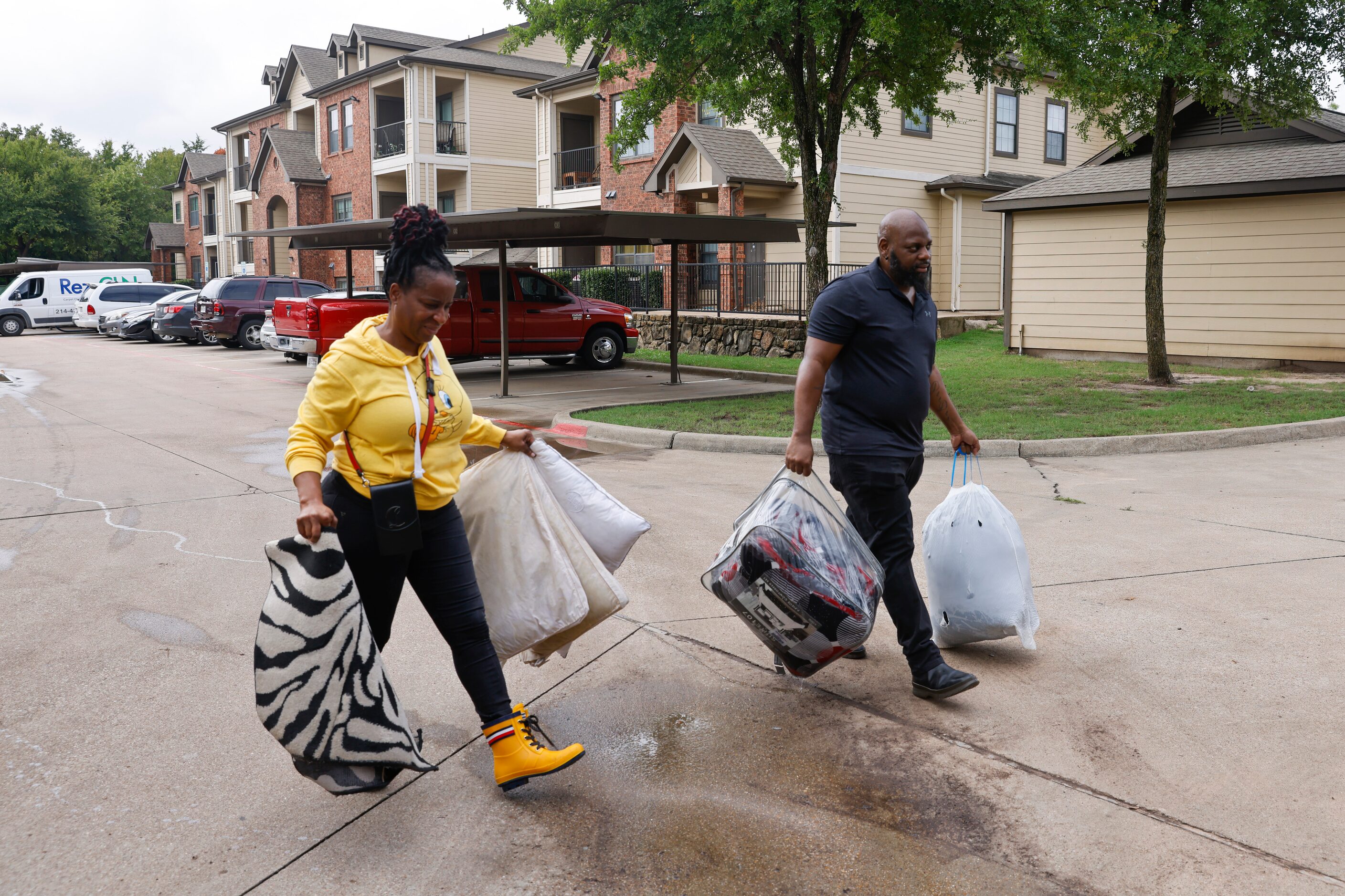 Home owners Michael and Latanya Benefield, move out their damaged belongings outside their...