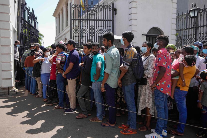 People queue up to enter the official residence of president Gotabaya Rajapaksa three days...