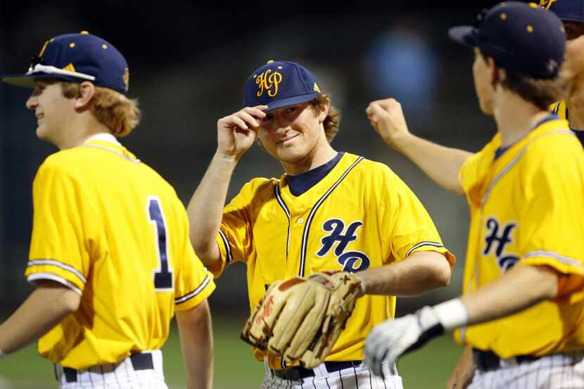Highland Park starting pitcher William Adair (center) is congratulated by teammates after...