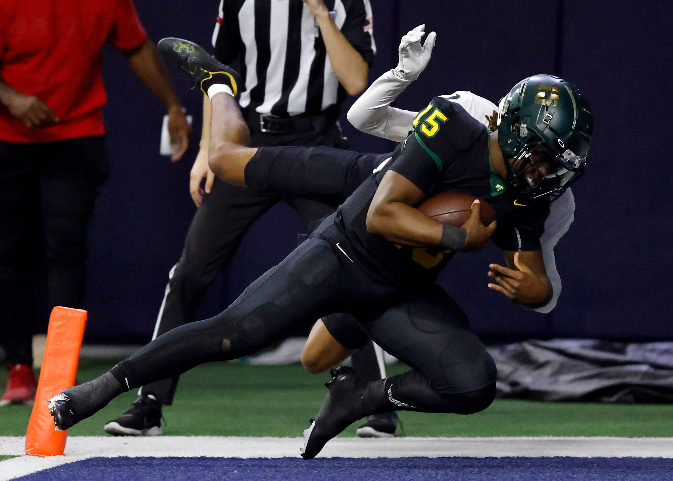 DeSoto quarterback Darius Bailey (15) carries Denton Guyer defensive back Brenden Bradshaw...