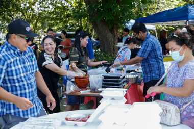 Residents prepare food for sale during a community fair and fundraiser for the Kachin state...