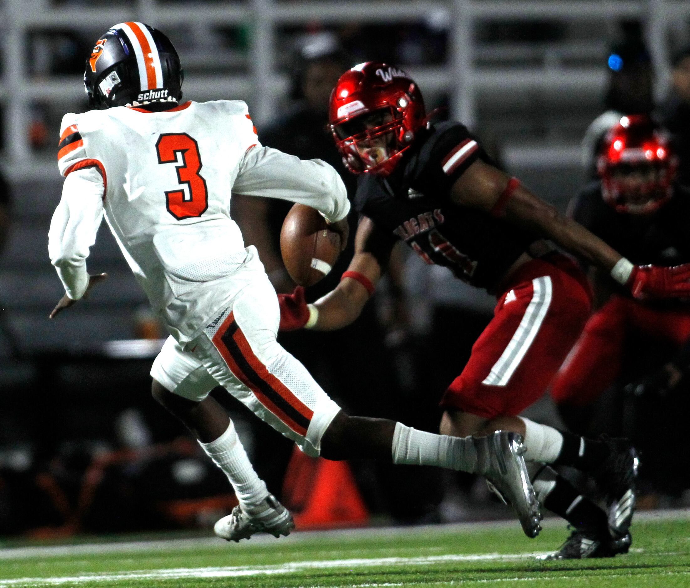 Lancaster quarterback Glenn Rice (3) rolls out of the pocket as he is pursued by Dallas...