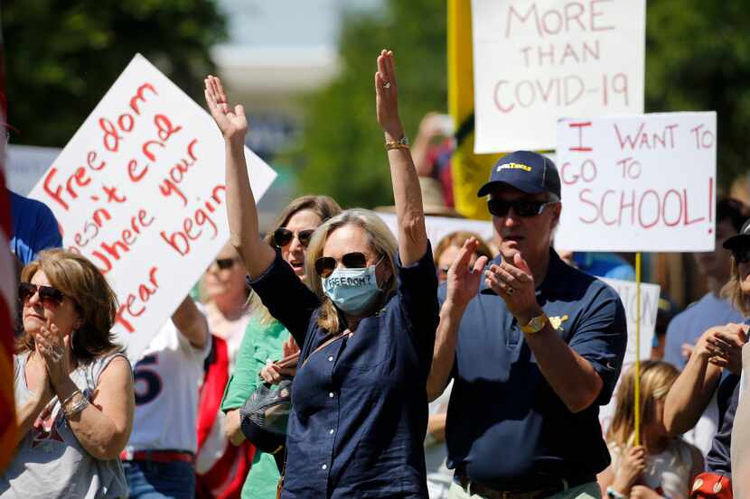 The crowd cheers during Saturday's Open Texas rally outside Frisco City Hall.