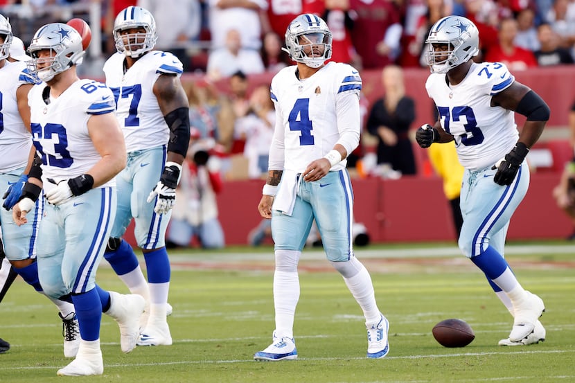 Dallas Cowboys quarterback Dak Prescott (4) looks to the video replay after being sacked on...