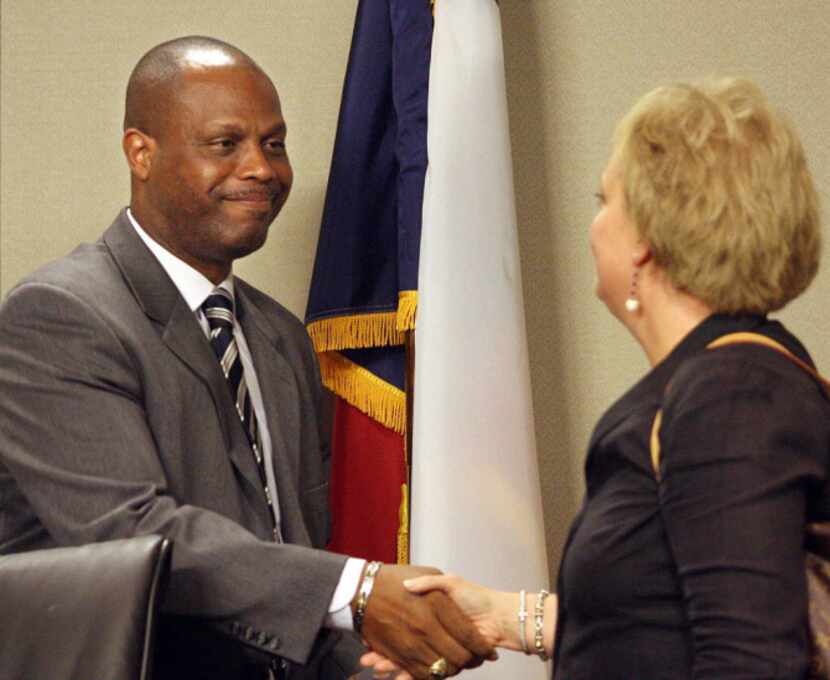 Irving ISD superintendent Dr. Dana Bedden shakes hands with board member Valerie Jones after...