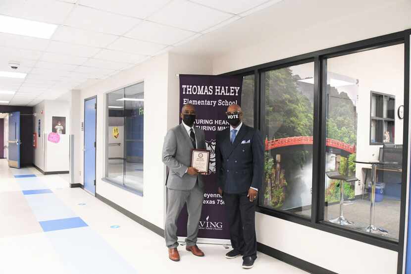 Principal Henry Taylor (left) is pictured with Tony Grimes, NAACP Irving-Carrollton chapter...