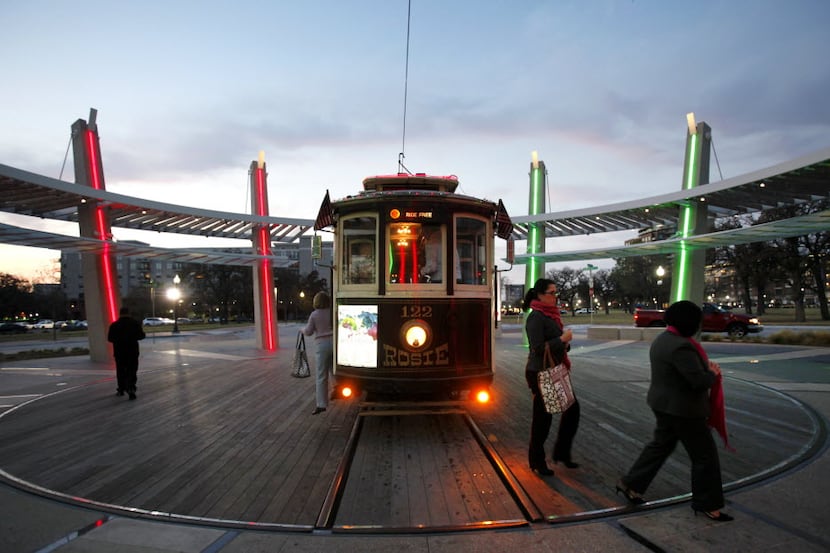 Passengers exit the McKinney Avenue trolley at the trolley turnaround near Central...
