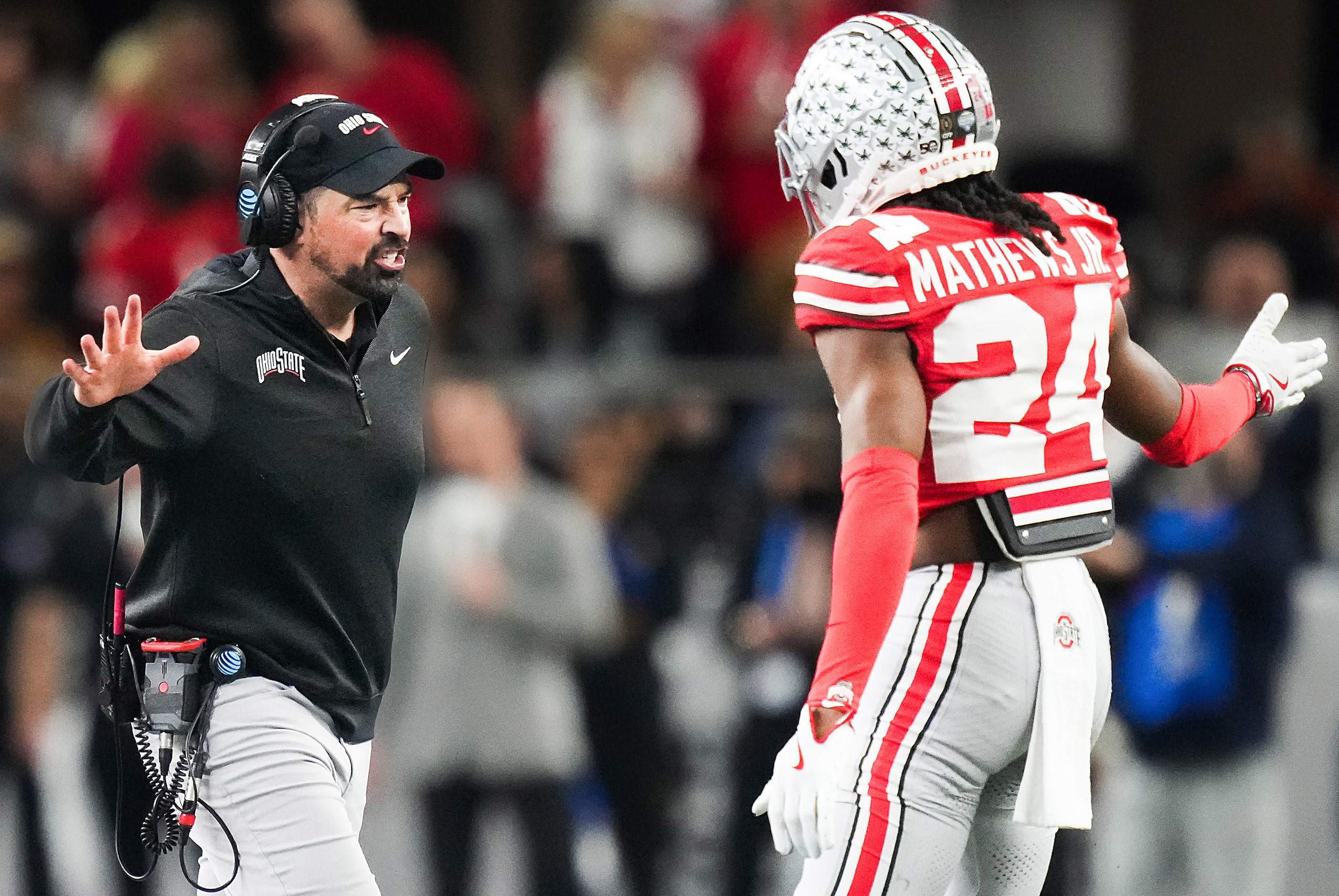 Ohio State head coach Ryan Day  celebrates with cornerback Jermaine Mathews Jr. (24) after...