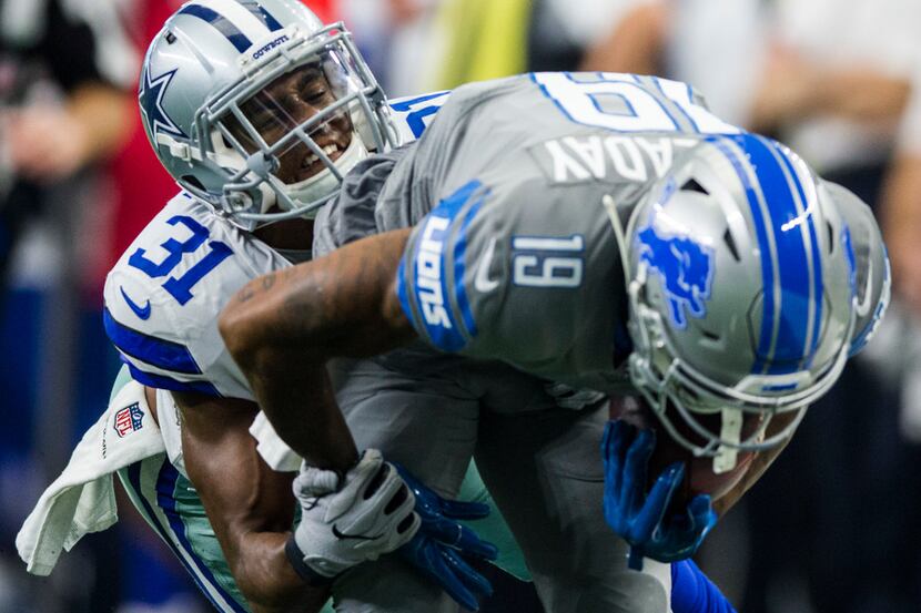 Dallas Cowboys cornerback Byron Jones (31) tackles Detroit Lions wide receiver Kenny...