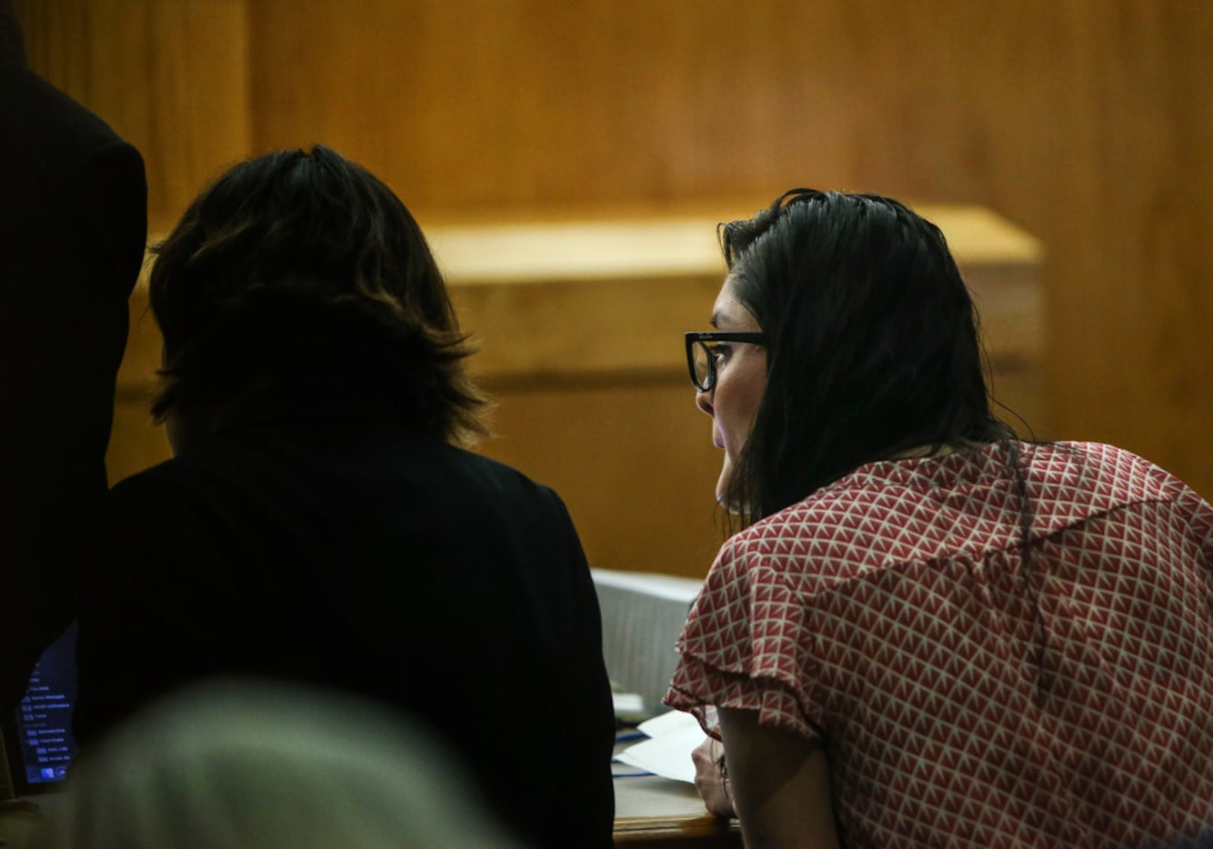 Brenda Delgado (right) speaks to an attorney during her murder trial in the 363rd Judicial...