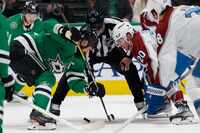 Dallas Stars left wing Jamie Benn (14) faces-off with Colorado Avalanche center Ross Colton...