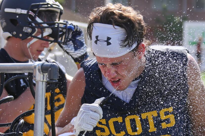 Highland Park defenders Walker French (22) and Stewart George (background) try to cool off...