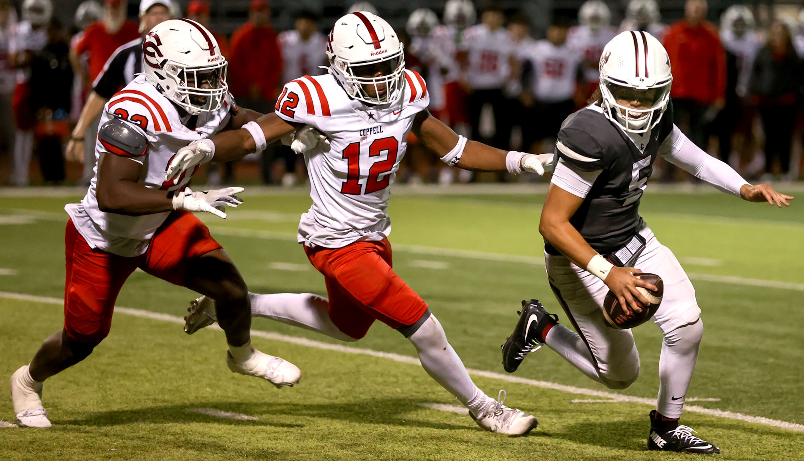 Lewisville quarterback Tre Williams (5) is chased by Coppell defensive lineman Uche Odimegwu...