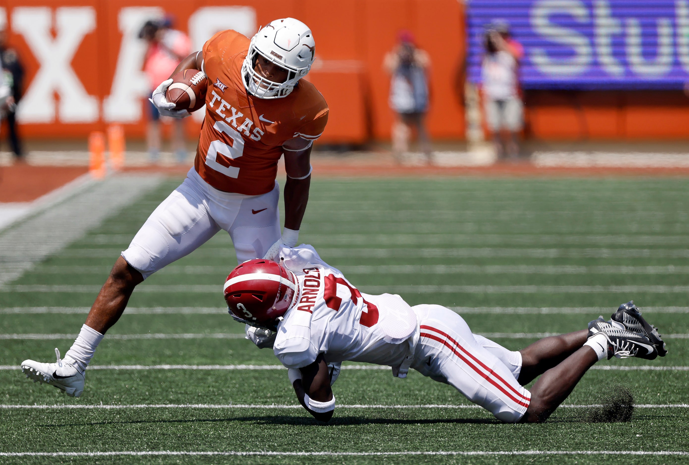 Texas Longhorns running back Roschon Johnson (2) is tackled by Alabama Crimson Tide...