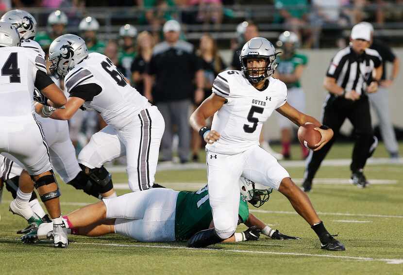 Denton Guyer sophomore quarterback Eli Stowers (5) evades a sack from Southlake Carroll...