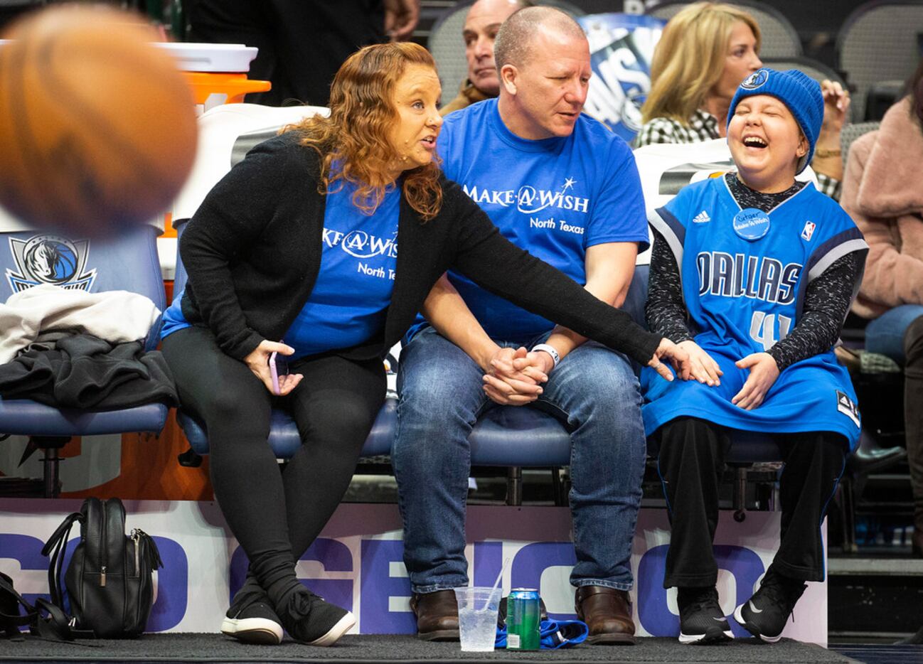 Make-A-Wish youngster Rutger McCrum laughs with his mom Heather and dad James as he watches...
