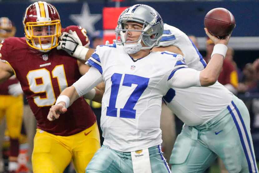 Dallas Cowboys quarterback Kellen Moore (17) throws a first-half pass under pressure from...