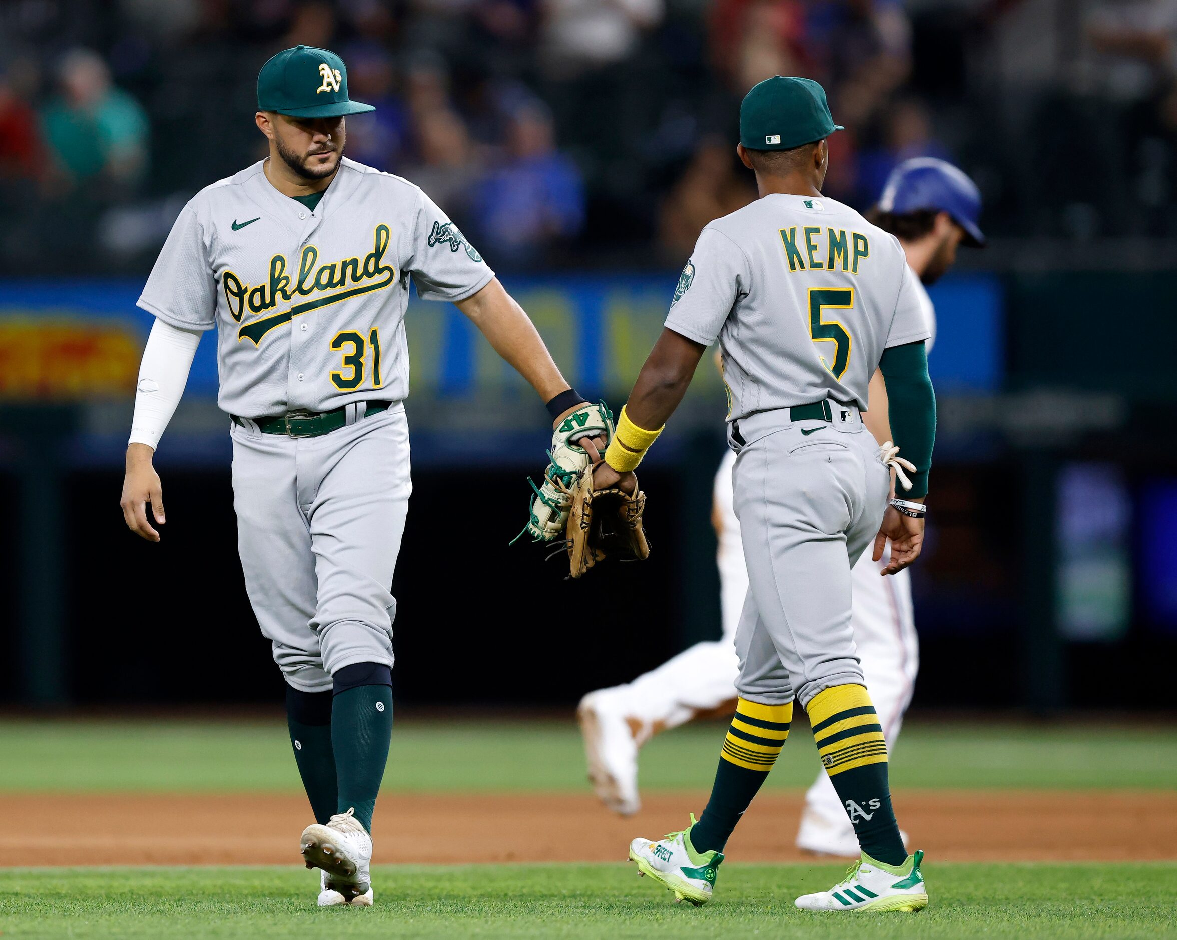 Oakland Athletics shortstop Vimael Machin (31) and second baseman Tony Kemp (5) tap gloves...