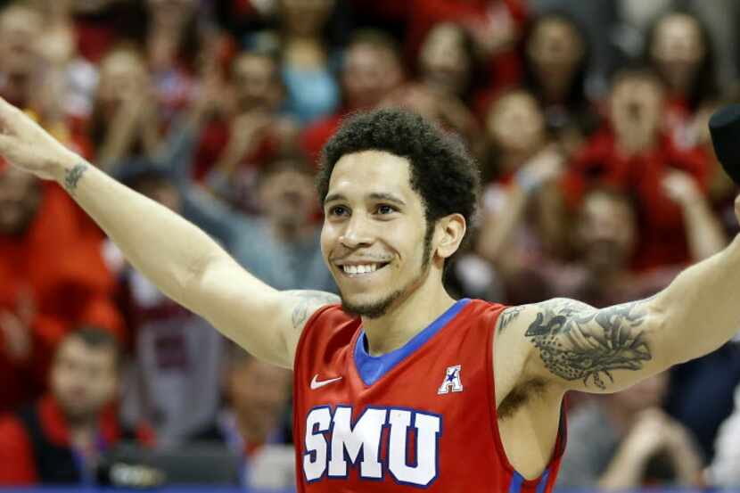 SMU guard Nic Moore smiles before speaking to the crowd after a 80-54 win over Connecticut...