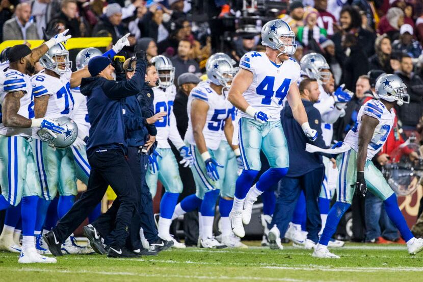 The Dallas Cowboys react to a turnover during the fourth quarter of their game against the...