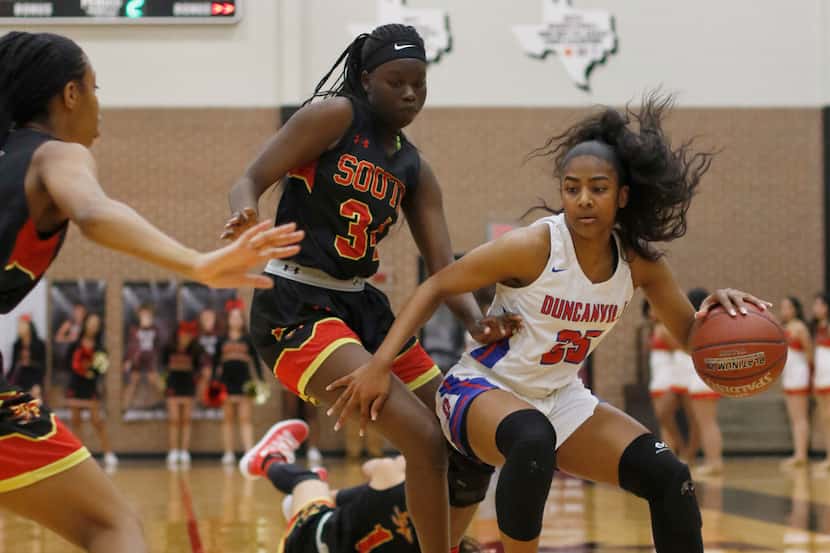 Duncanville guard Deja Kelly (25) drives to the basket during a first-round playoff game...