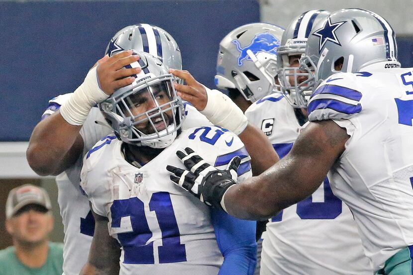 Teammates congratulate Dallas Cowboys running back Ezekiel Elliott (21) on his touchdown in...