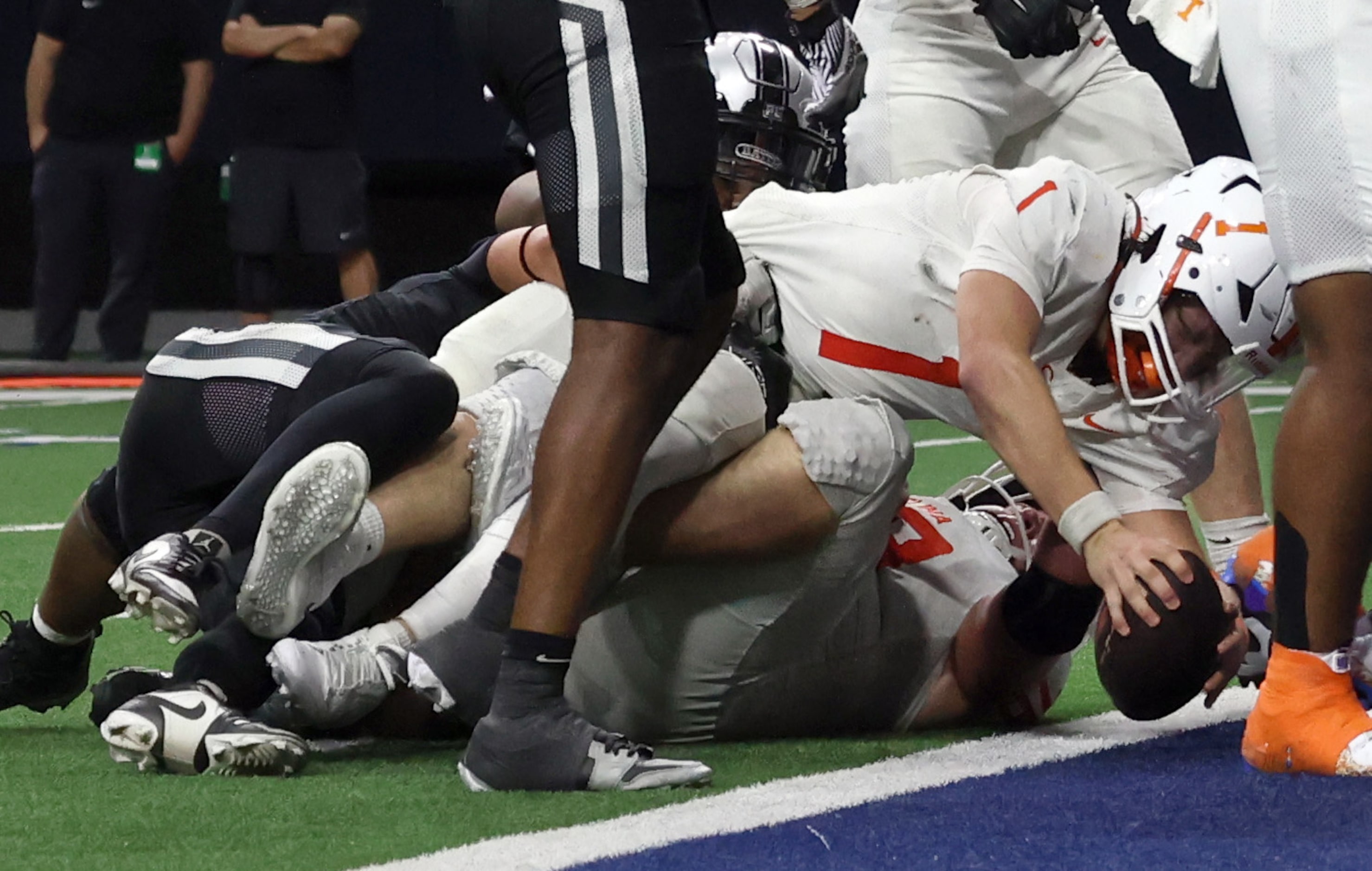 Celina quarterback Bowe Bentley (1) dives over a teammate to cross the goal line for a first...