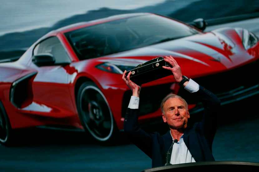 Tadge Juechter, Corvette executive chief engineer, holds up the trophy after the new...