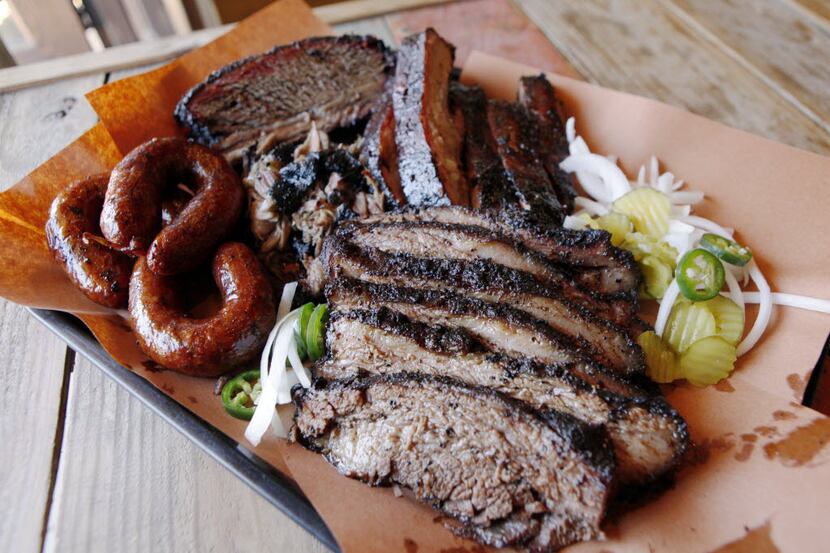 The family style platter with beef rib, brisket, pork ribs, pulled pork and sausage from the...
