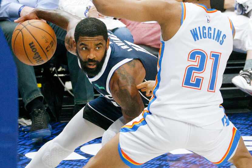 Dallas Mavericks guard Kyrie Irving (11) tries to drive past Oklahoma City Thunder guard...