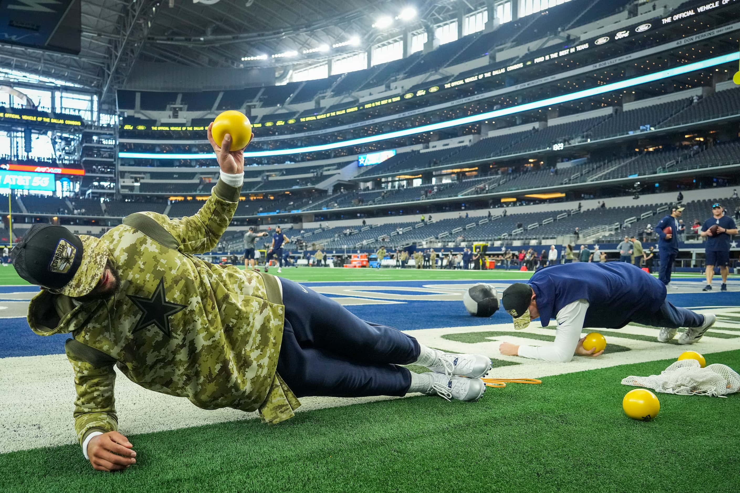 Dallas Cowboys quarterback Dak Prescott (left) and quarterback Cooper Rush stretch before an...