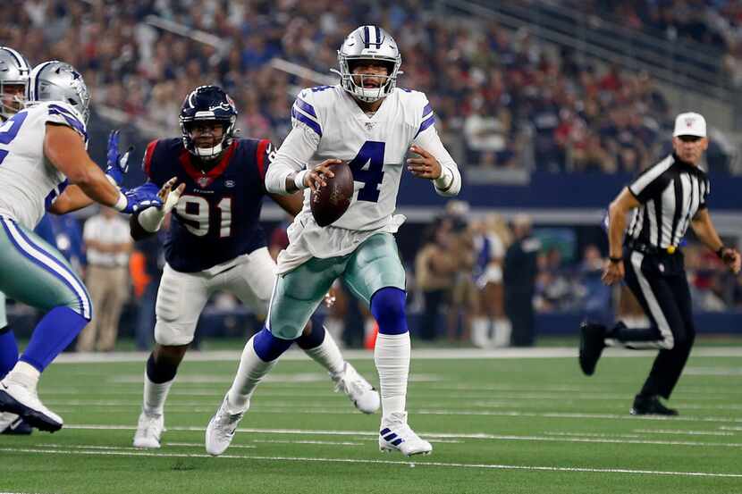 Dallas Cowboys quarterback Dak Prescott (4) scrambles out of the pocket under pressure from...