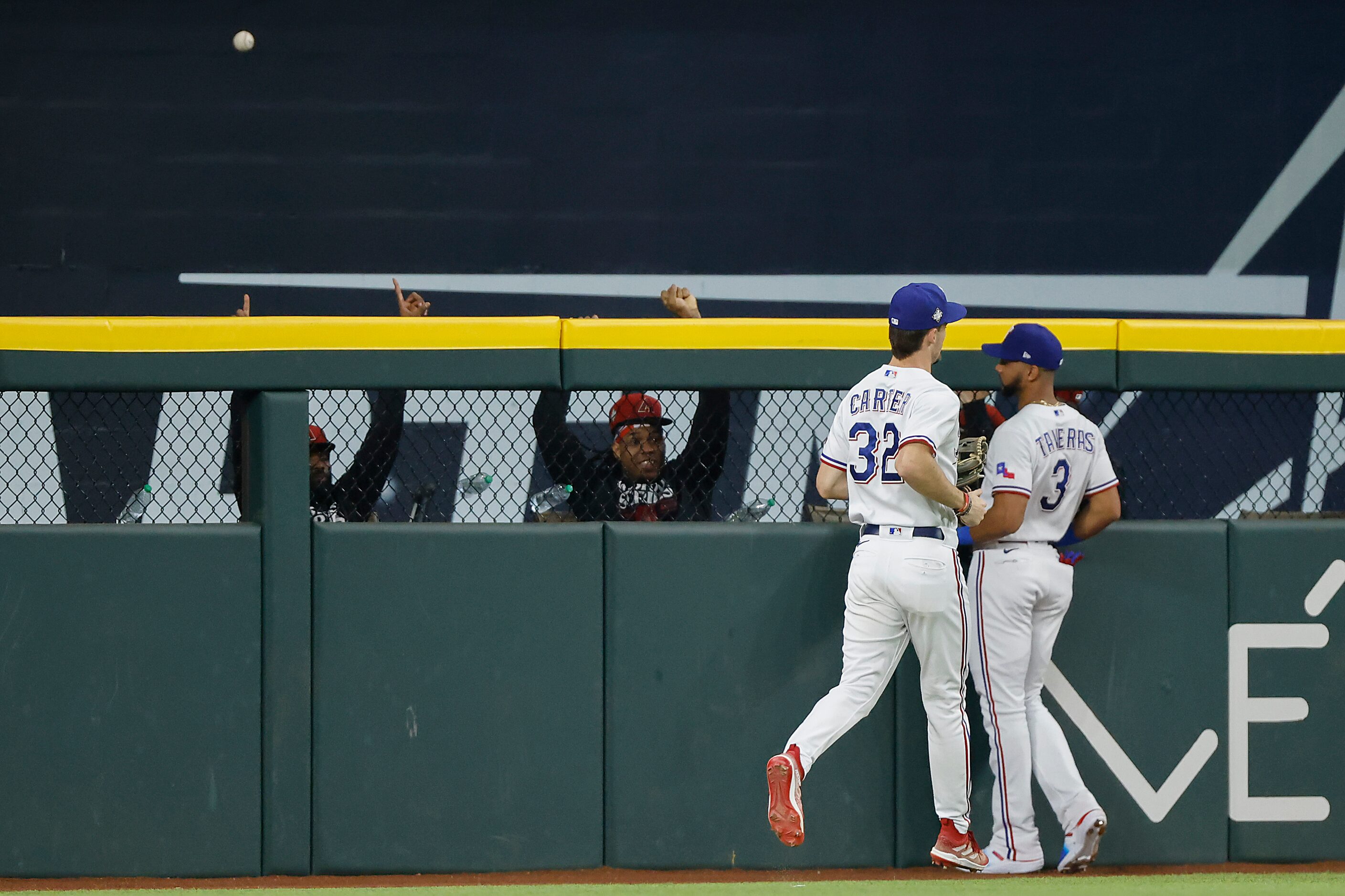 Pitchers in the Arizona Diamondbacks bullpen celebrate as Texas Rangers center fielder Leody...