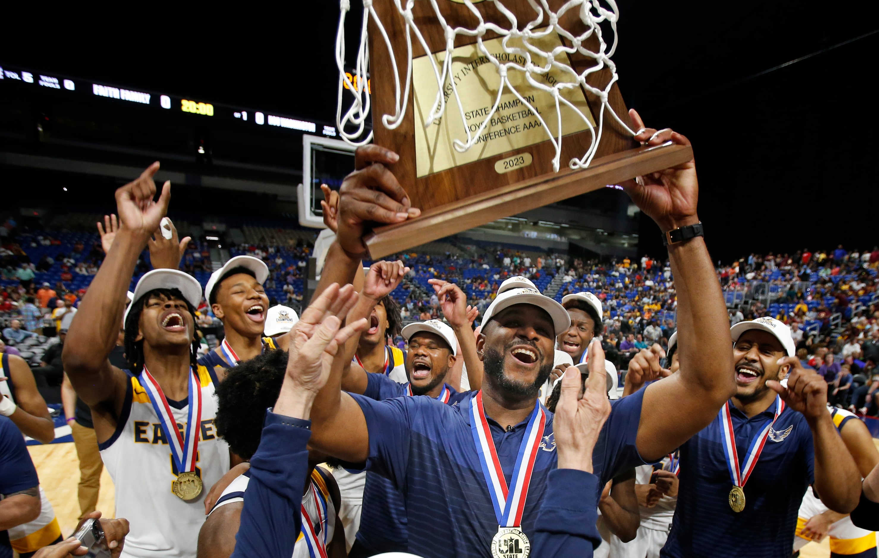 Oak Cliff Faith Family Academy head coach Brandon Thomas holds up their trophy. Dallas Oak...